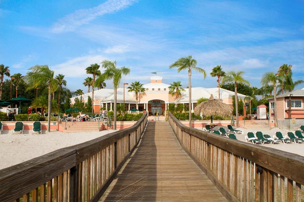 un paseo marítimo de madera que conduce a un complejo en la playa en Summer Bay Orlando by Exploria Resorts en Orlando