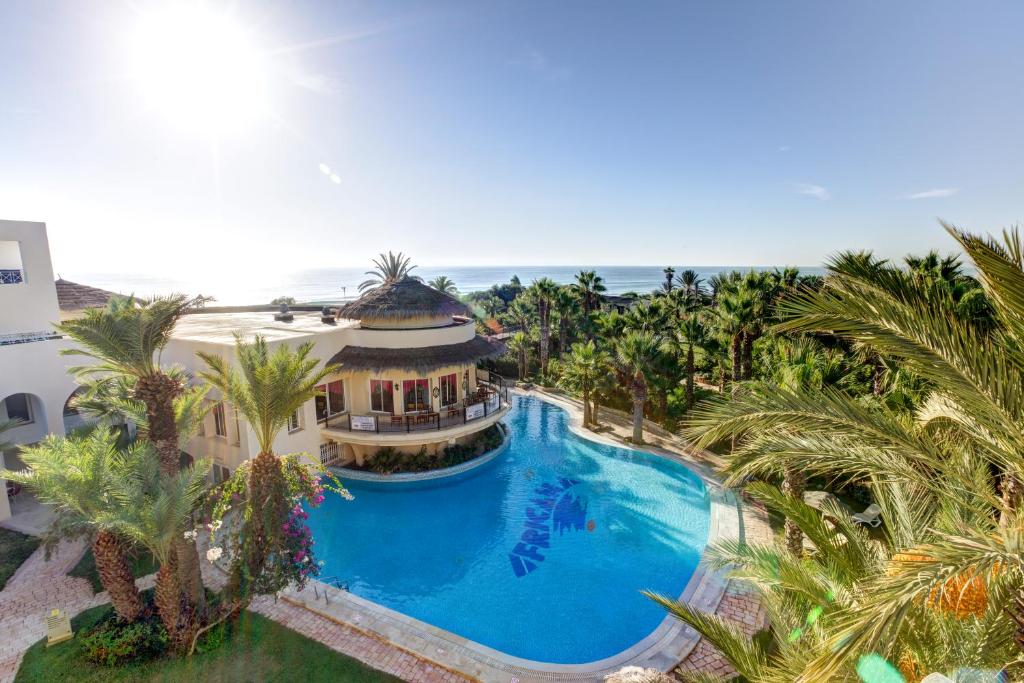 an aerial view of a house with a swimming pool and the ocean at TUI MAGIC LIFE Africana in Hammamet