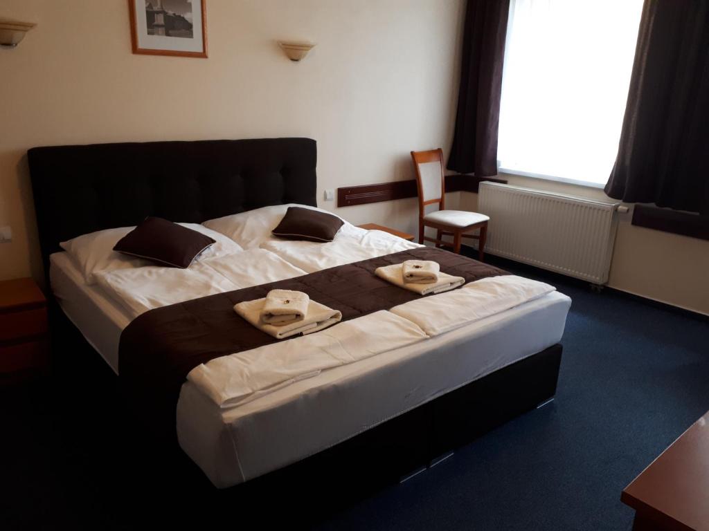 Posteľ alebo postele v izbe v ubytovaní Garni Hotel Tatramonti