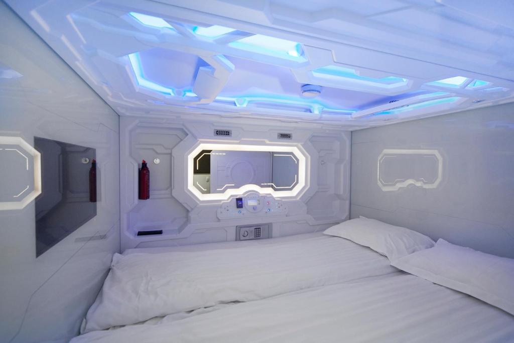 a bedroom with two beds and a window in an airplane at Galaxy Pod Hostel in Reykjavík