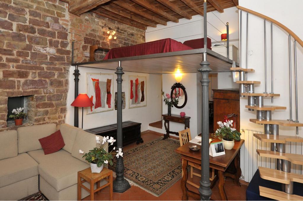 a living room with a couch and a loft at Florence Rental in Florence