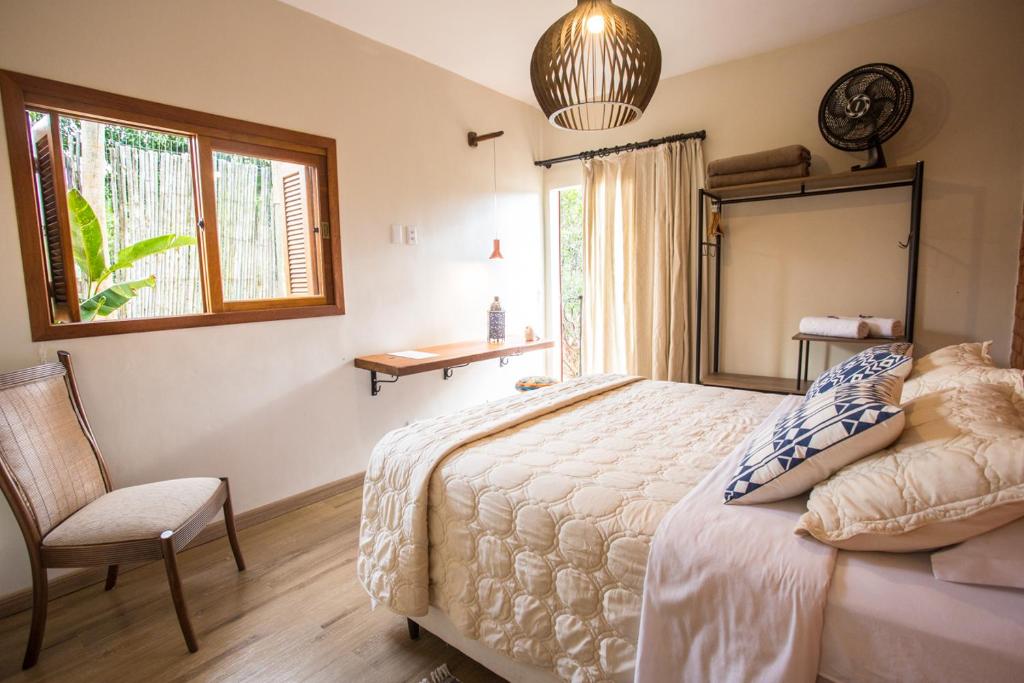Postel nebo postele na pokoji v ubytování Vilarejo Guesthouse - Silêncio e Aconchego
