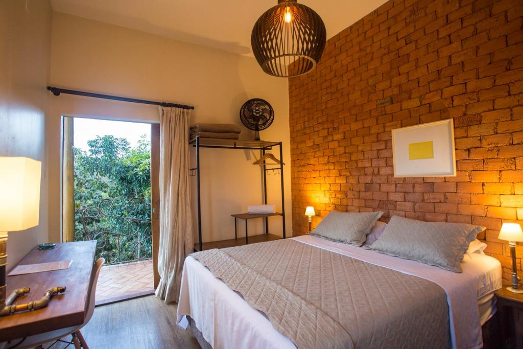Postel nebo postele na pokoji v ubytování Vilarejo Guesthouse - Silêncio e Aconchego