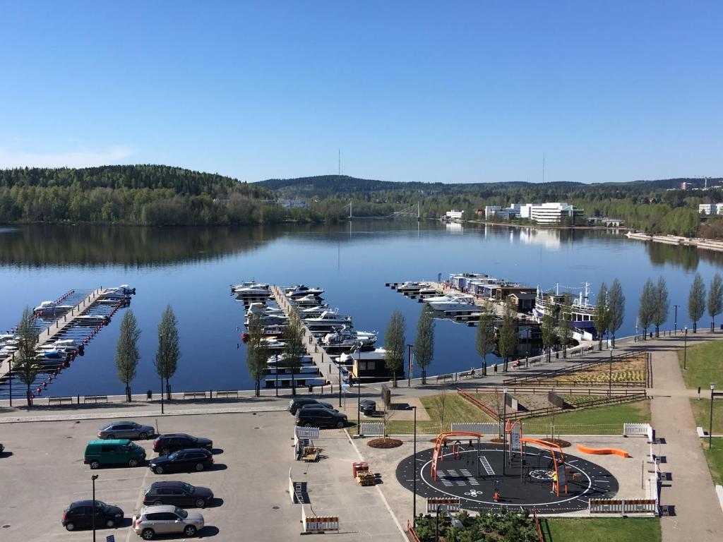 a parking lot next to a marina with parked cars at Sonaatti Studio - best lake view in Jyväskylä