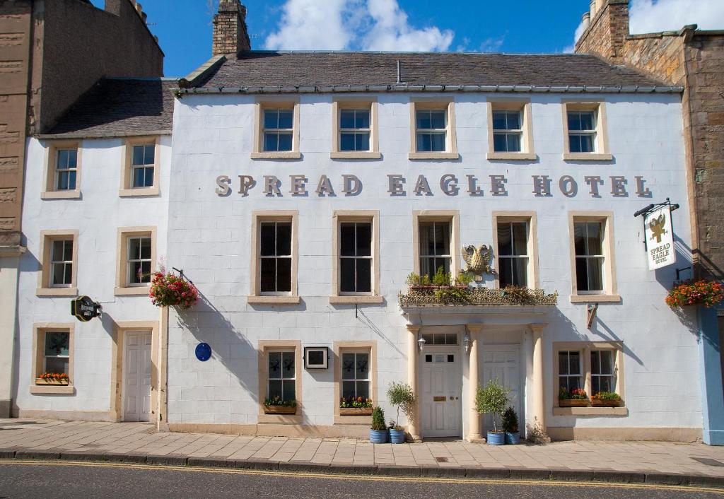 a white building with the words spread eagle hotel on it at The Spread Eagle Hotel in Jedburgh