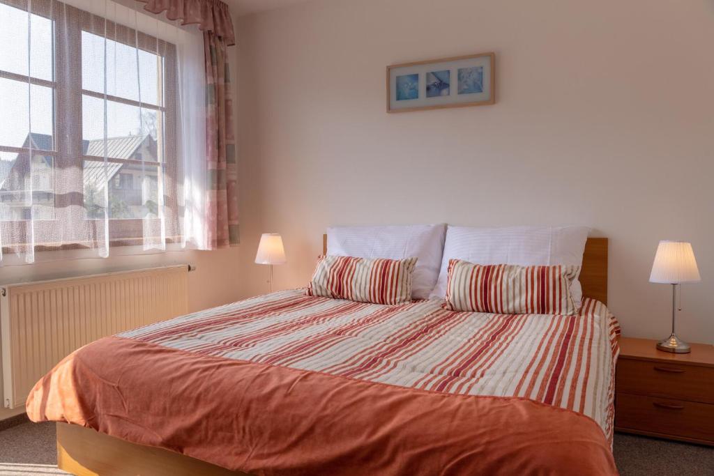 Postel nebo postele na pokoji v ubytování Apartmany Aneta