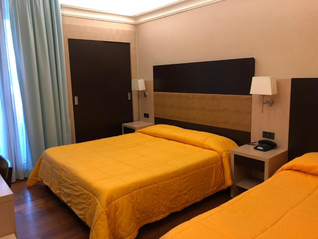 Posteľ alebo postele v izbe v ubytovaní Hotel Enrichetta