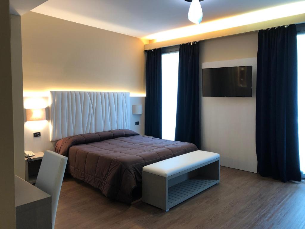 Posteľ alebo postele v izbe v ubytovaní Hotel Enrichetta