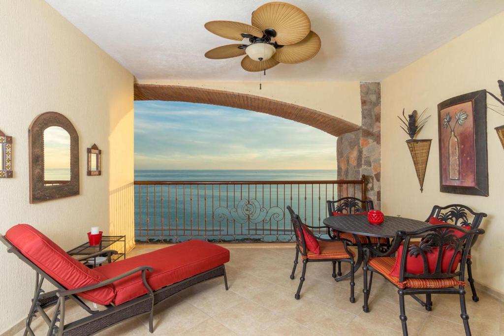 a dining room with a view of the ocean at Sonoran Sky 1BR 1506 by Casago in Puerto Peñasco