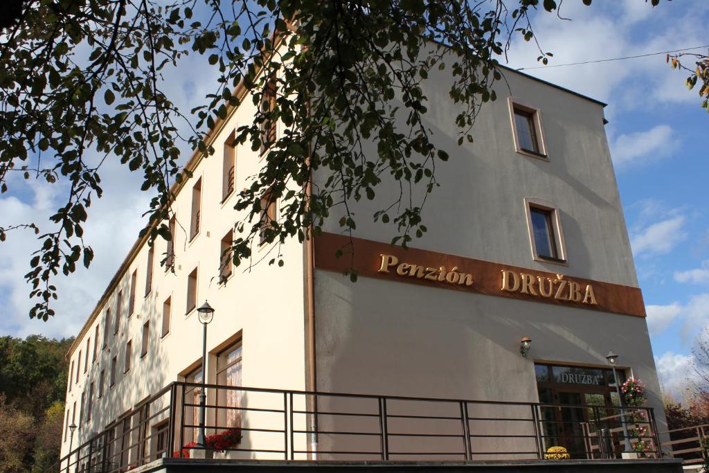 a building with a sign on the side of it at Penzión DRUŽBA Bojnice in Bojnice