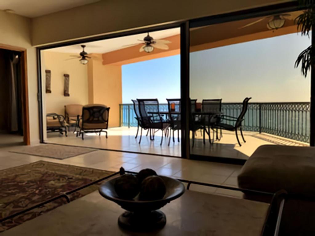 a living room with a view of a table and chairs at Sonoran Sea 3BR Deluxe SSE 608 by Casago in Puerto Pe&ntilde;asco