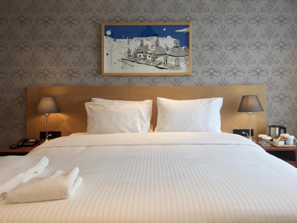 Postel nebo postele na pokoji v ubytování Four-G Hotel
