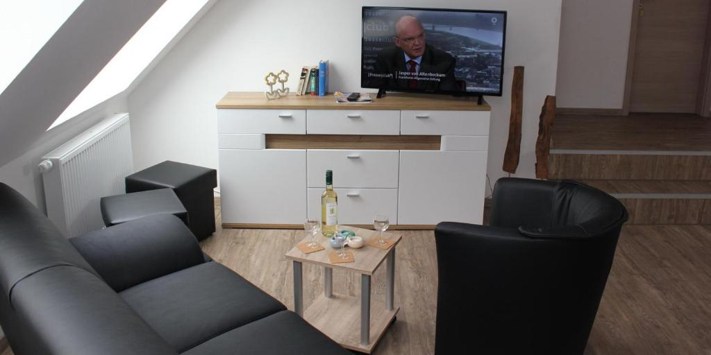 a living room with a couch and a tv at Schünenbusch in Minden
