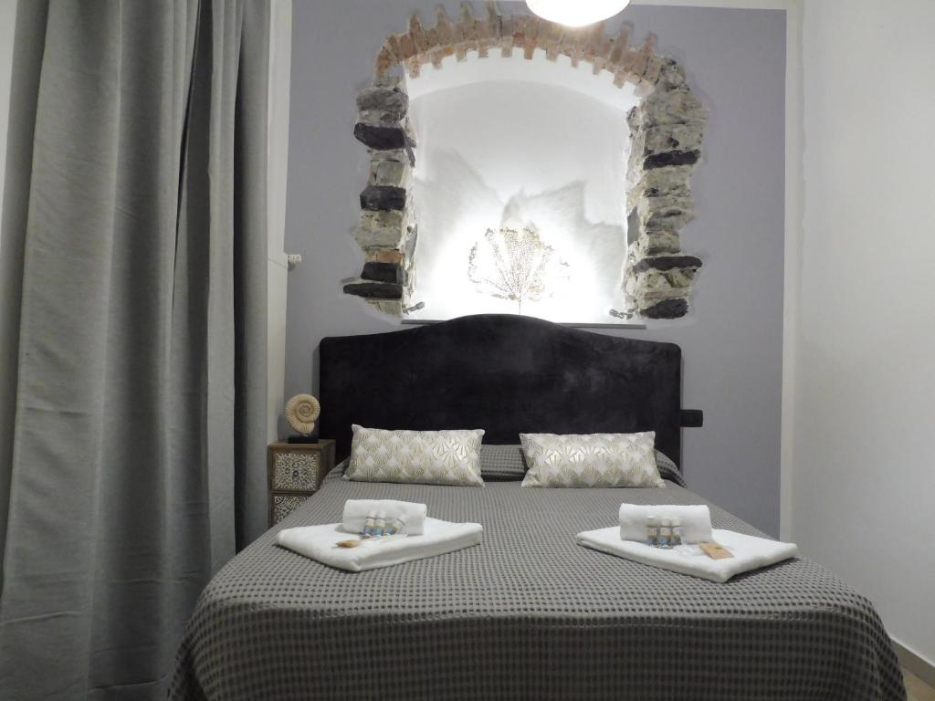 a bedroom with a bed with two towels on it at Rio Groppo Guesthouse in Manarola