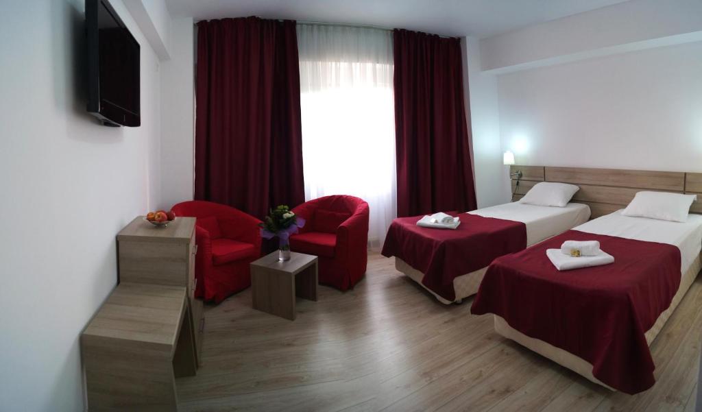 Postel nebo postele na pokoji v ubytování Hotel Otopeni