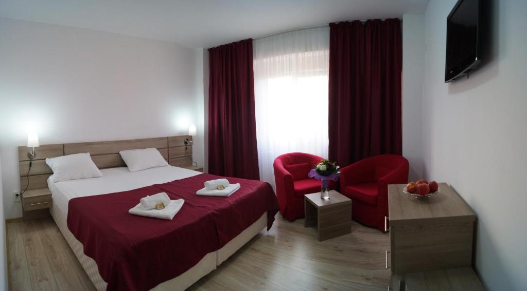 Postel nebo postele na pokoji v ubytování Hotel Otopeni