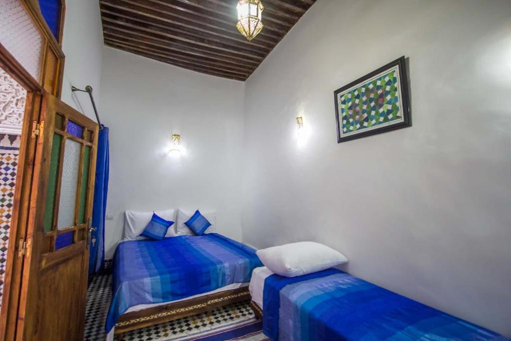 Llit o llits en una habitació de DAR MILOUDA RCIF