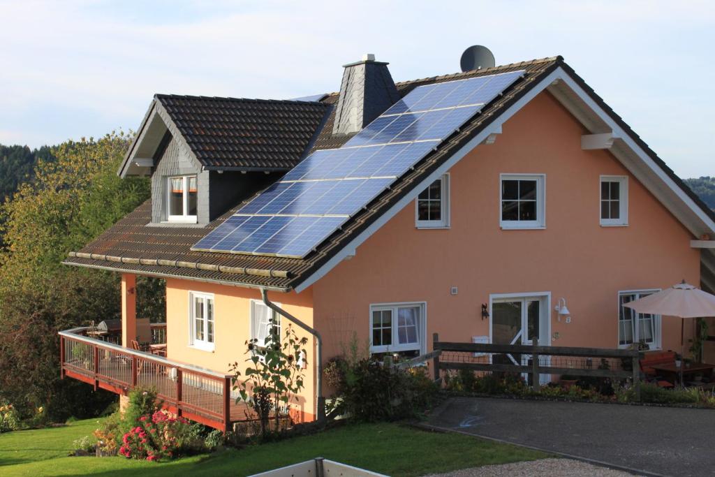 a house with solar panels on the roof at Ferienwohnung Schmahl in Schleiden