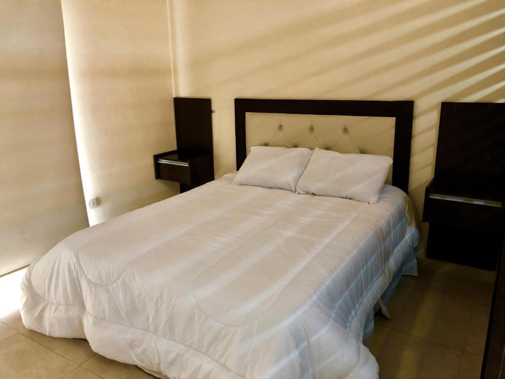 En eller flere senge i et værelse på Departamento Centrico C/ Asador Propio