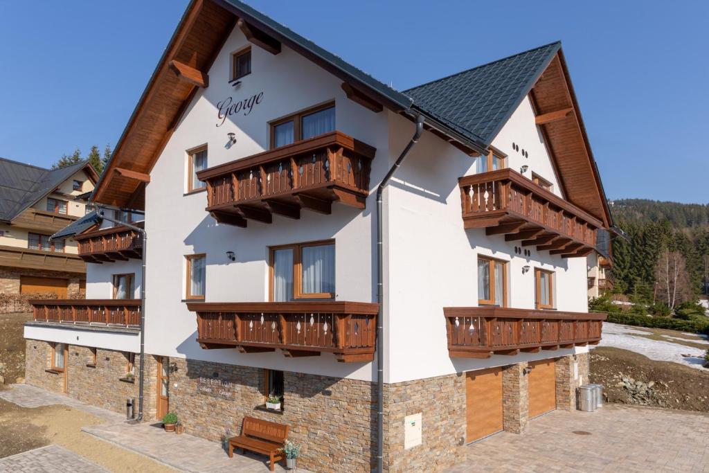 a building with balconies on the side of it at pension George in Špindlerův Mlýn