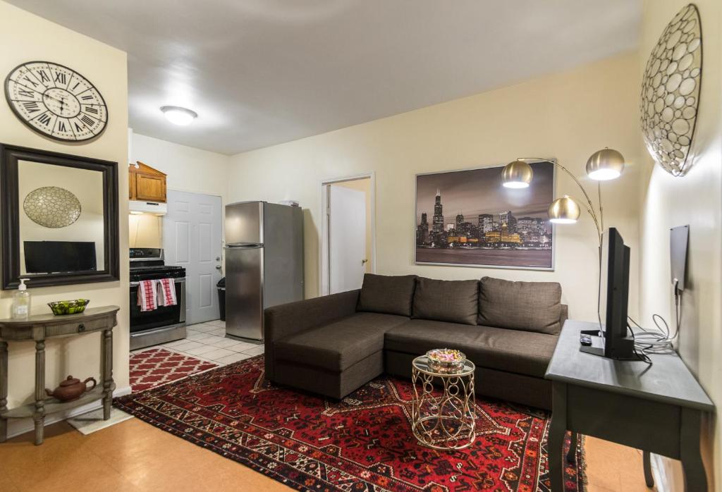 a living room with a couch and a tv at 1549 North Maplewood Avenue in Chicago