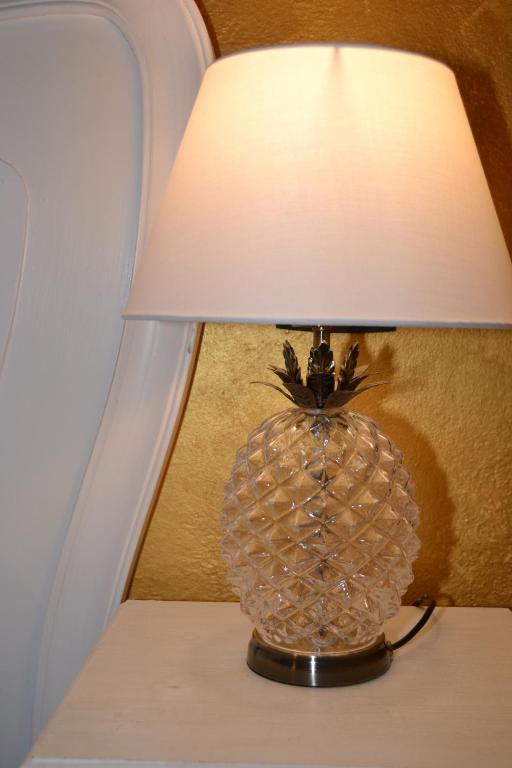 a lamp on a table with a pineapple on it at Rio Groppo Guesthouse in Manarola