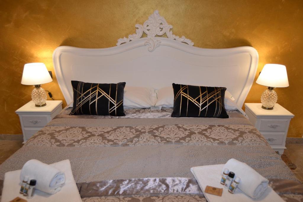 a bedroom with a large bed with two lamps at Rio Groppo Guesthouse in Manarola