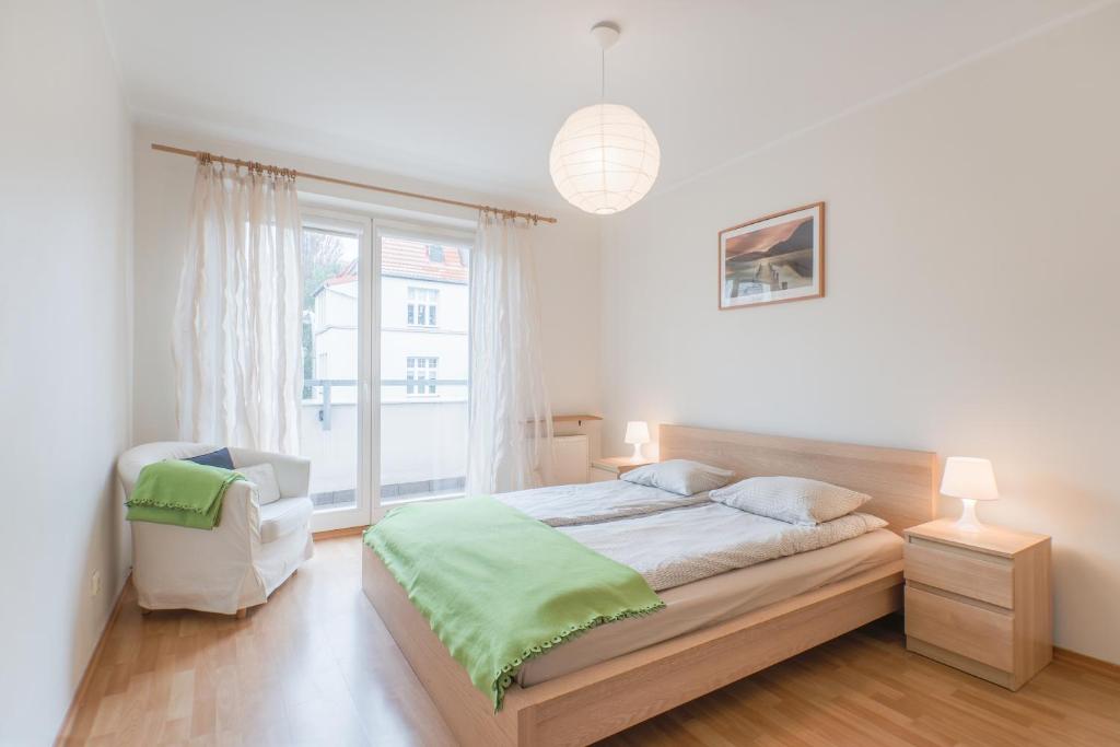 ソポトにあるCITYSTAY Okrzei Sopot Apartmentの白いベッドルーム(ベッド1台、窓付)
