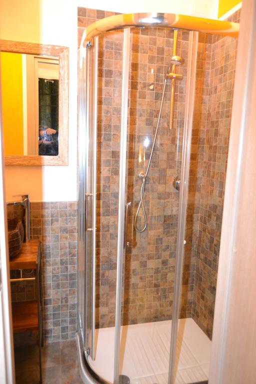 a shower with a glass door in a bathroom at Rio Groppo Guesthouse in Manarola