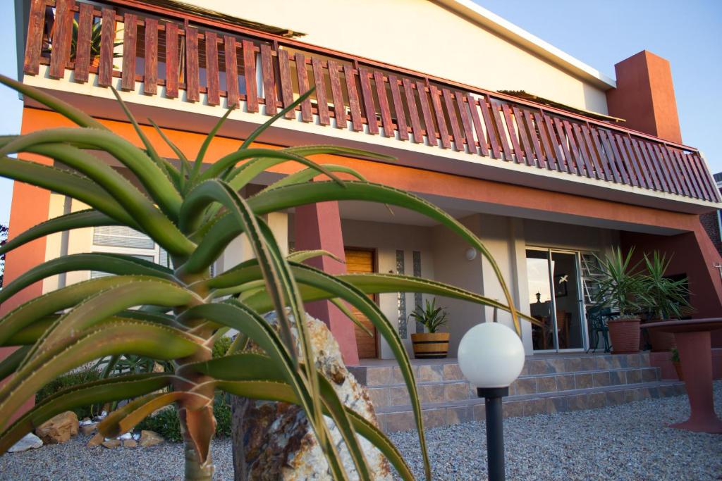 a house with a plant in front of it at Haus Giotto in Gansbaai