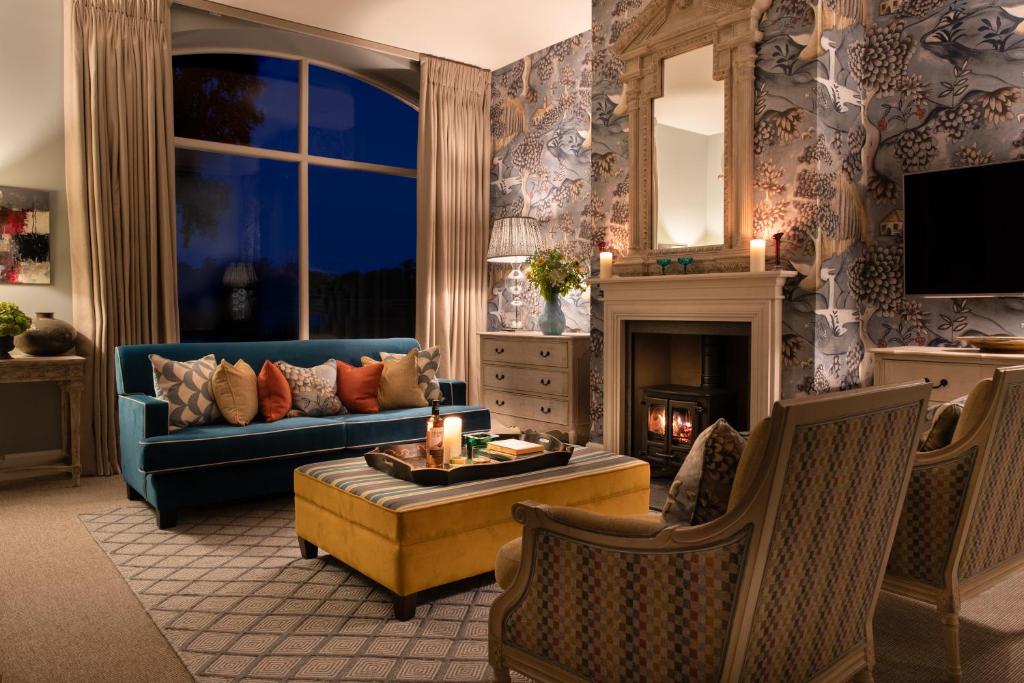 a living room with a blue couch and a fireplace at Newhall Mains in Resolis