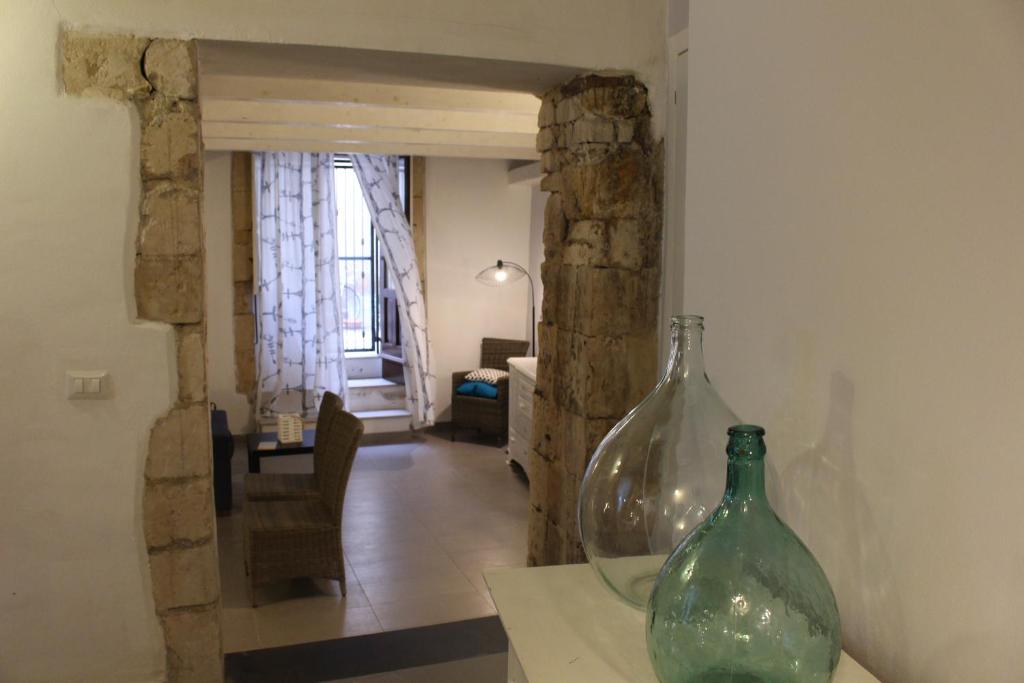 two glass vases sitting on a table in a room at Magica Ortigia in Syracuse