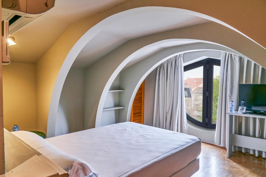 A bed or beds in a room at Sotopalacio HSR