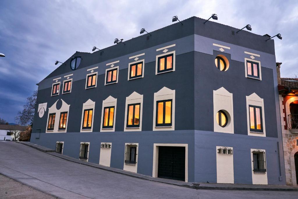 a blue building with a clock on top of it at Sotopalacio HSR in Madrona