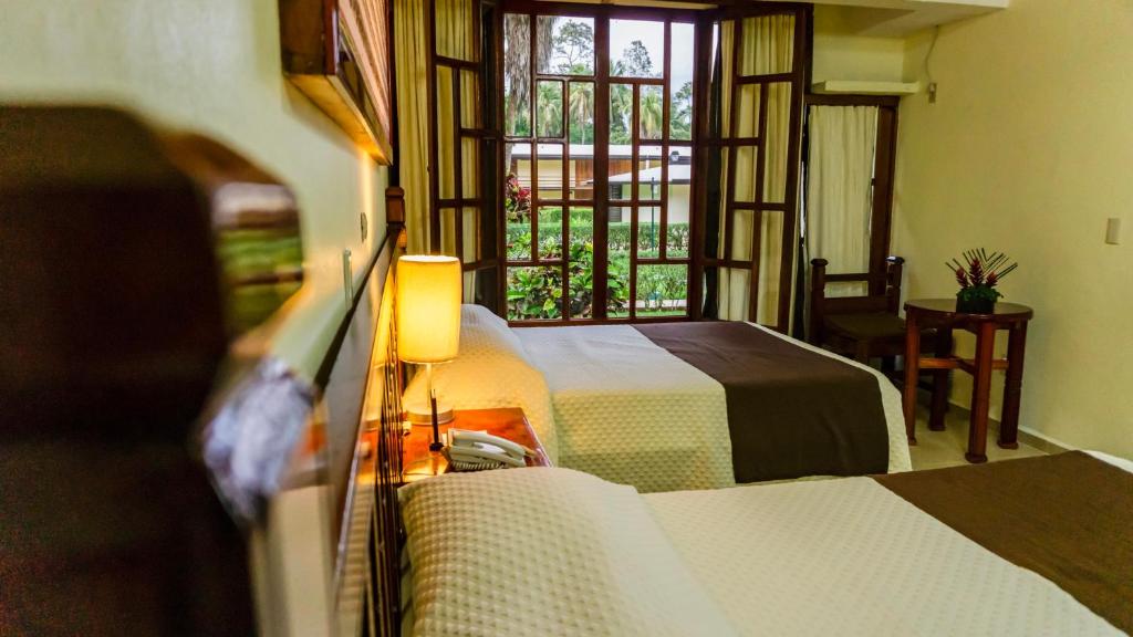 Postel nebo postele na pokoji v ubytování Hotel Nututun Palenque