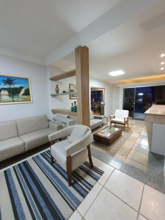 a living room with a couch and a table at Guaratur Hotel in Linhares