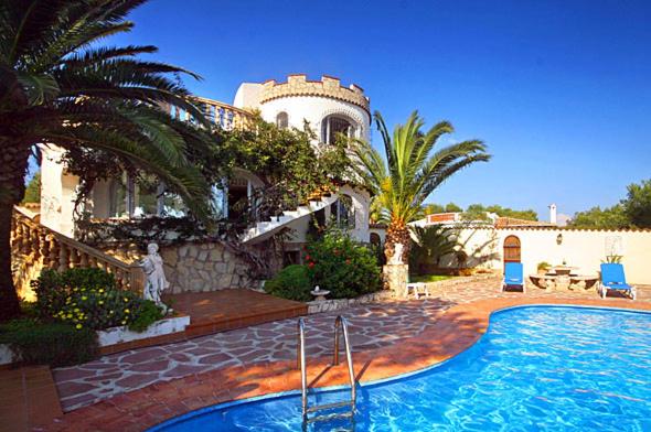 a house with a swimming pool in front of a house at Casa Resa in Jávea