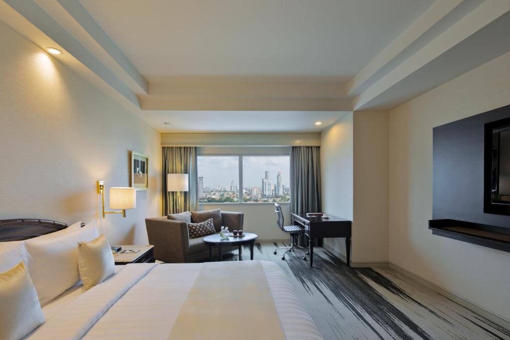 Postel nebo postele na pokoji v ubytování Gran Melia Jakarta