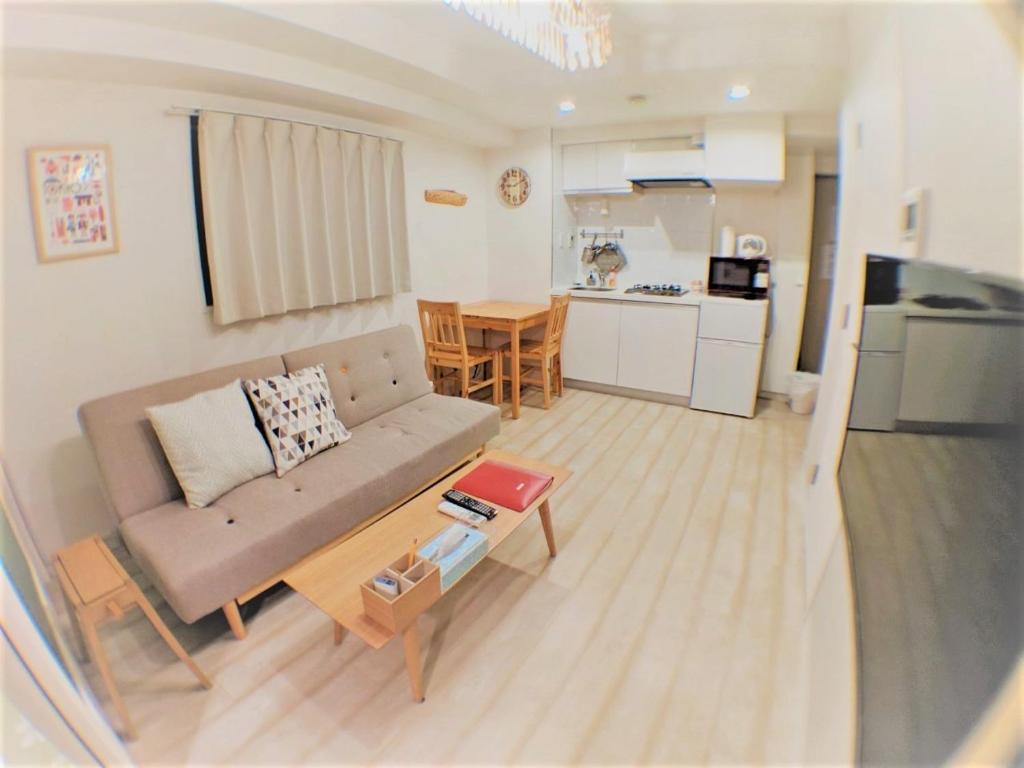 a small living room with a couch and a table at 歌舞伎町/新宿站徒歩可#东新宿站徒歩3分#现代简约温馨公寓#最多3人 in Tokyo
