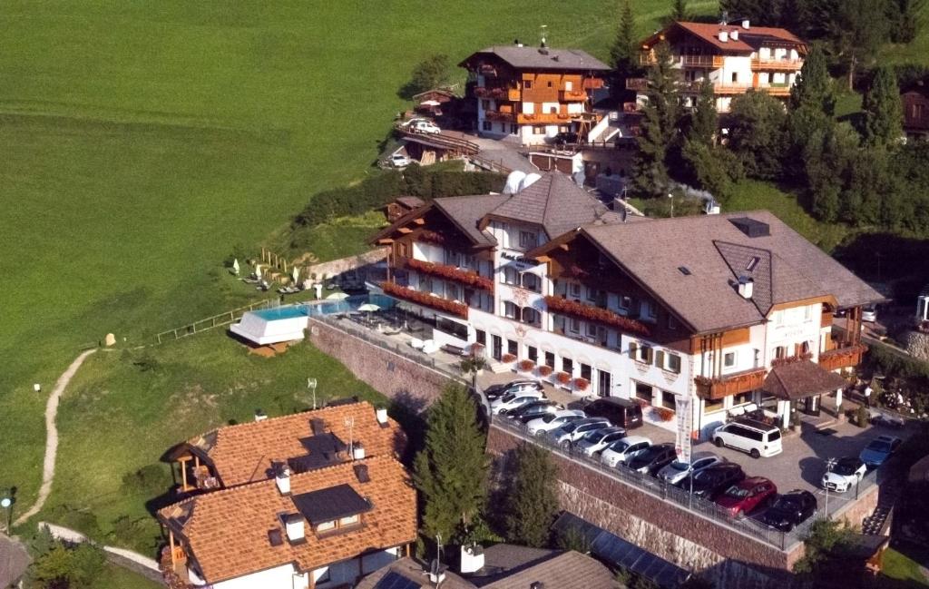 an aerial view of a large house with a parking lot at Hotel Interski in Santa Cristina Gherdëina