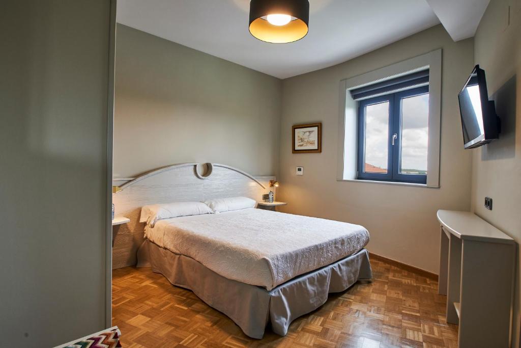 A bed or beds in a room at Sotopalacio HSR
