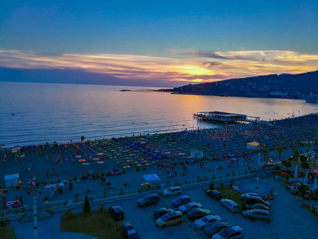 a crowd of people at a beach at sunset at Nada SeaView Apartment in Shëngjin
