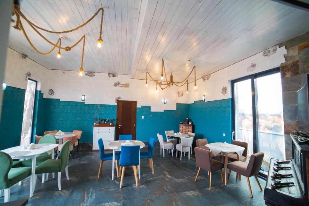 a dining room with tables and chairs and blue walls at Da Vinci Residence in Sibiu