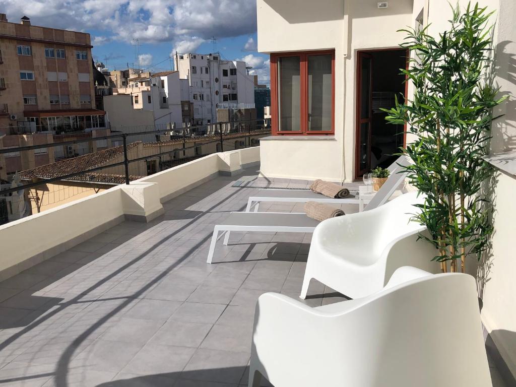 a balcony with white benches on a building at ÁTICO EN EL CENTRO DE VALENCIA Pta 12 VT-45939-T in Valencia