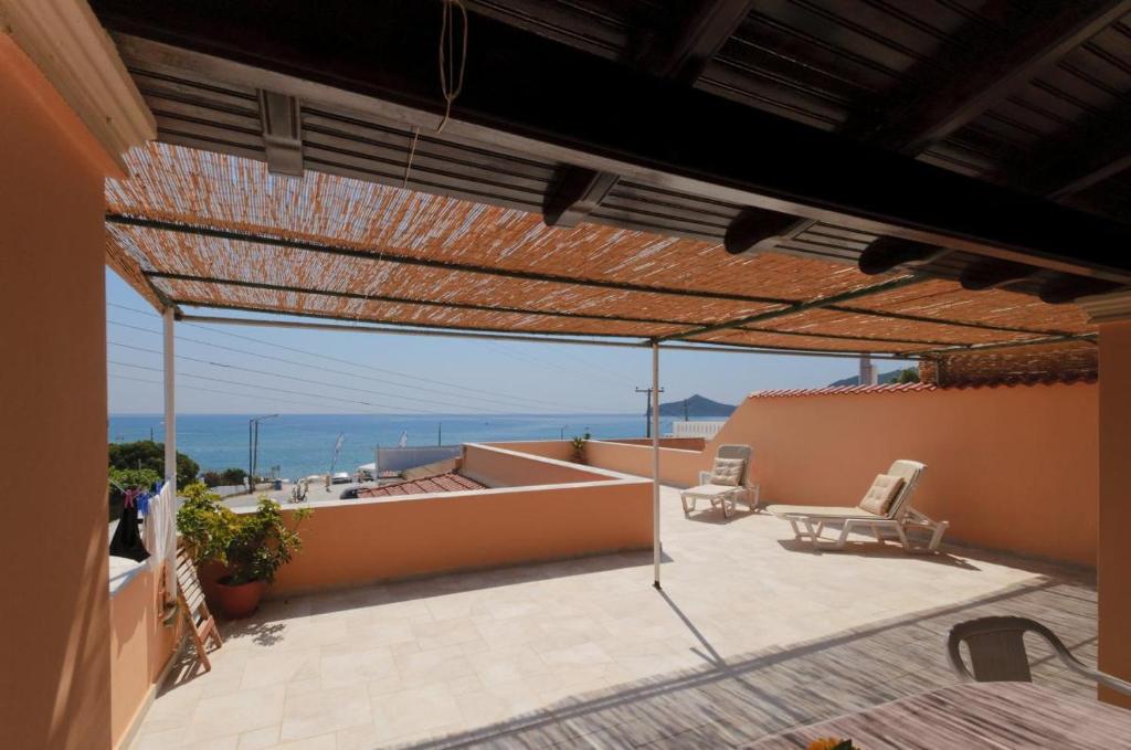 a patio with a view of the ocean from a house at Patras Roof apartment in Agios Georgios Pagon