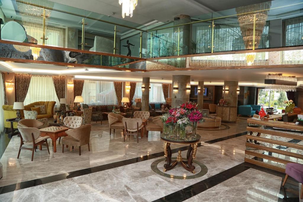 a lobby with chairs and tables and a living room at Tuzla Garden Hotel & Spa in Tuzla