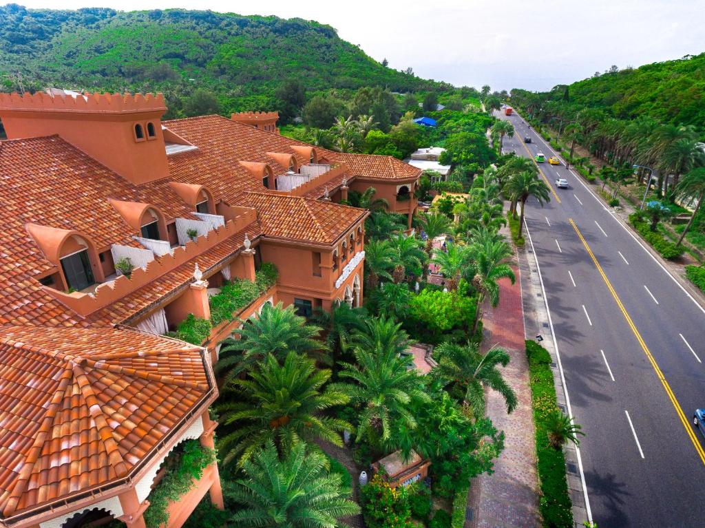 arial view of a house with palm trees and a road at Kenting Amanda Hotel in Nanwan