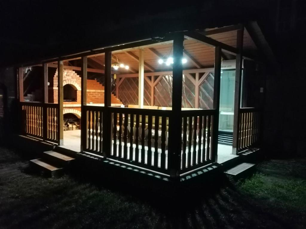 a screened porch at night with a light on it at Casa UILA in Orşova