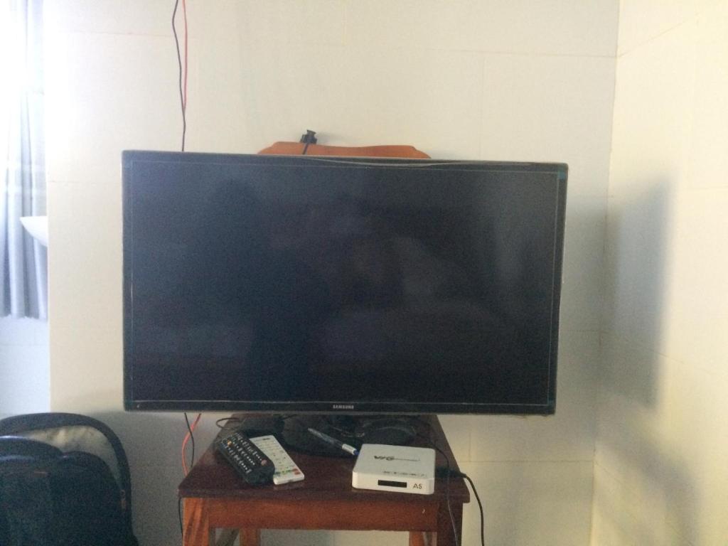 a flat screen tv sitting on a table with remote controls at Khách sạn Ngọc Quỳnh in Lagi
