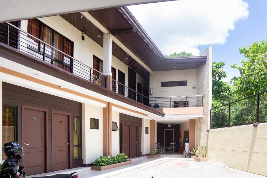 a house with two balconies and a garage at OYO 153 Espacio de Clarita Hometel in Davao City